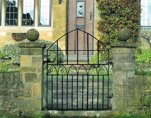 Gothic arched metal garden gate fitted to front entrance of home