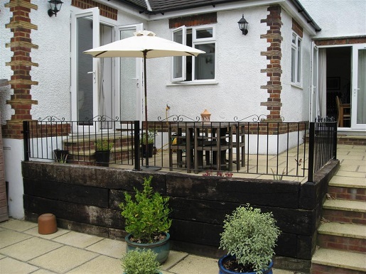 Metal garden railings fitted to raised terrace area