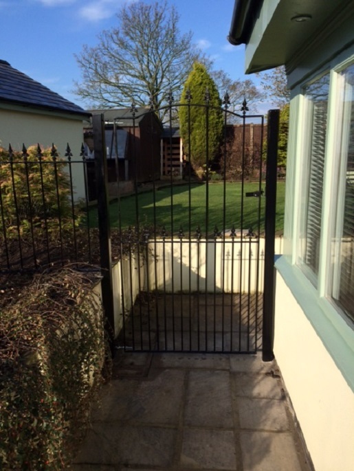 Saxon tall metal side gate fitted to posts securing pedestrian entrance