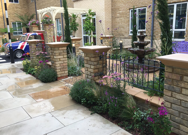 Manor ball top metal railings fitted to brick pillars in hospital garden