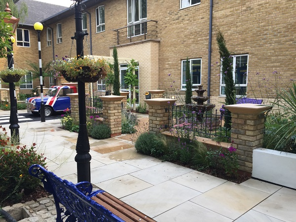 Metal garden railings with ball top finials fitted to brick walls 