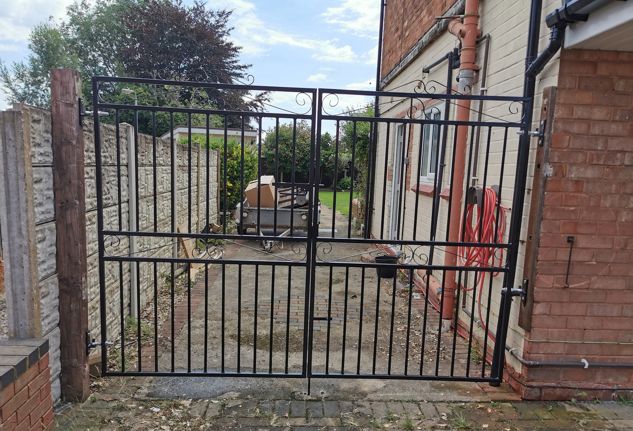 Marlborough wrought iron style estate gates fitted to wooden posts
