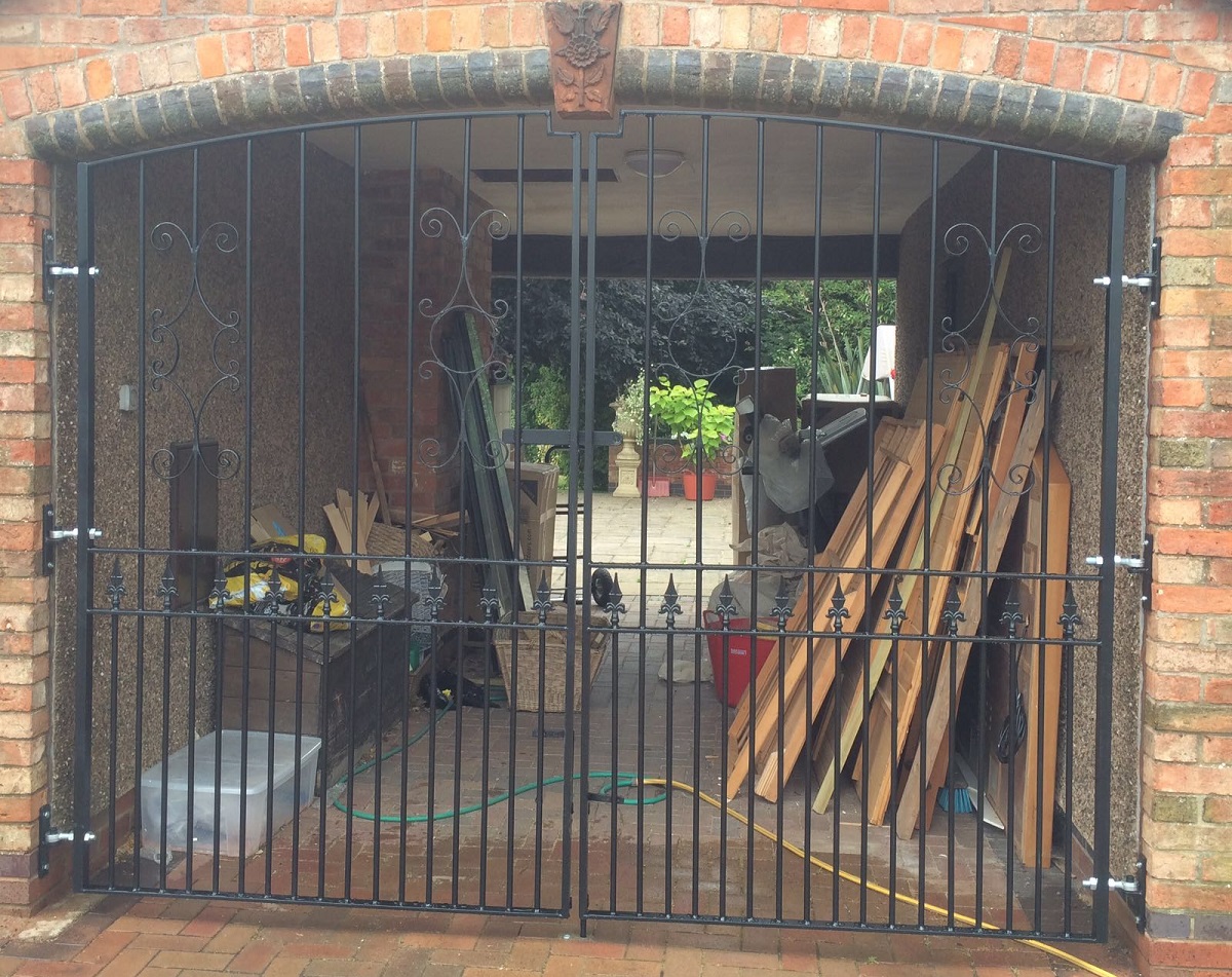 Wrought iron style estate gates adding security to a courtyard entrance