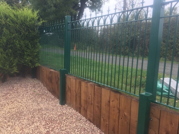 Wrought iron style fence panels with bespoke posts finished in a racing green powder coated paint